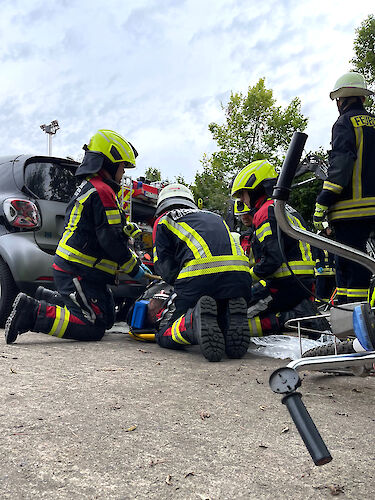 Feuerwehrkräfte betreuen einen Patienten nach einem Verkehrsunfall.